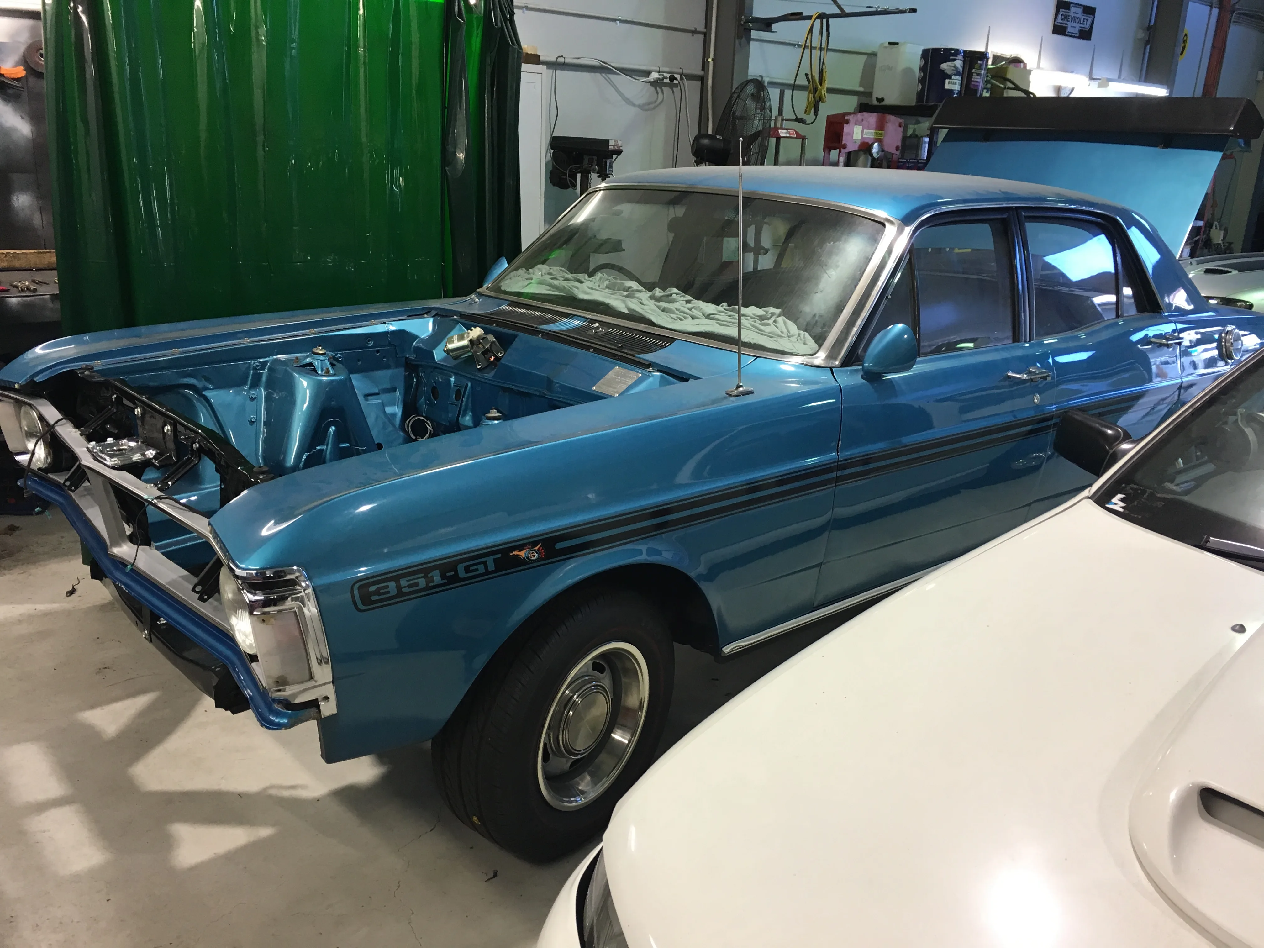 Blue classic ute in the Totally Wired workshop during electrical work